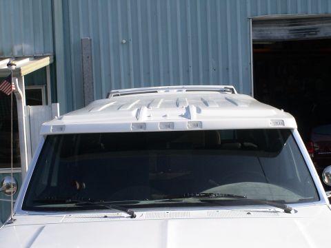 1993 Ford C-350 (Centurion Conversions) - A white truck's custom visor with clearance lights is shown from the front.