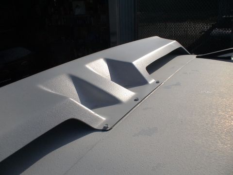 1993 Ford C-350 (Centurion Conversions) - Aftermarket hood scoop with vents, bolted onto a vehicle's hood.