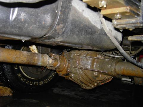 1995 GMC C/K Pickup - Undercarriage view of a truck's rear differential and driveshaft, showing signs of rust and wear.