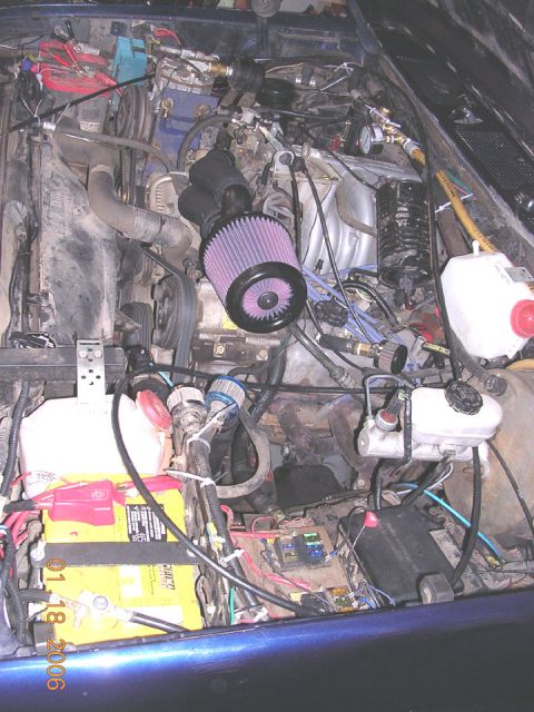1994 Ford Bronco - The engine bay shows an aftermarket air intake system and a yellow battery with visible text.