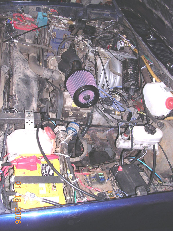 Modified engine bay with cone air filter, Optima yellow-top battery and onboard air system