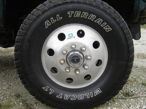 1995 GMC C/K Pickup - Close-up of a truck's wheel and tire, showing tire brand and lug nut configuration.