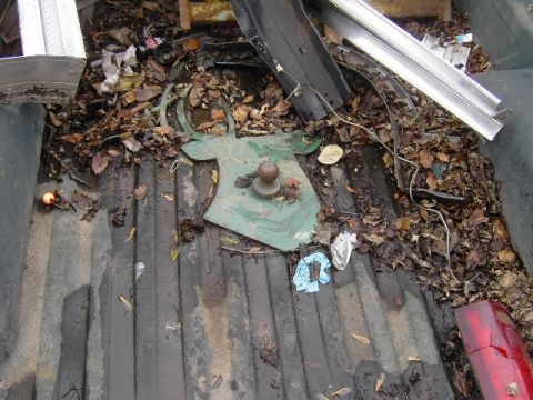 1995 GMC C/K Pickup - A green deer head hitch cover is visible in the cluttered bed of a pickup truck.