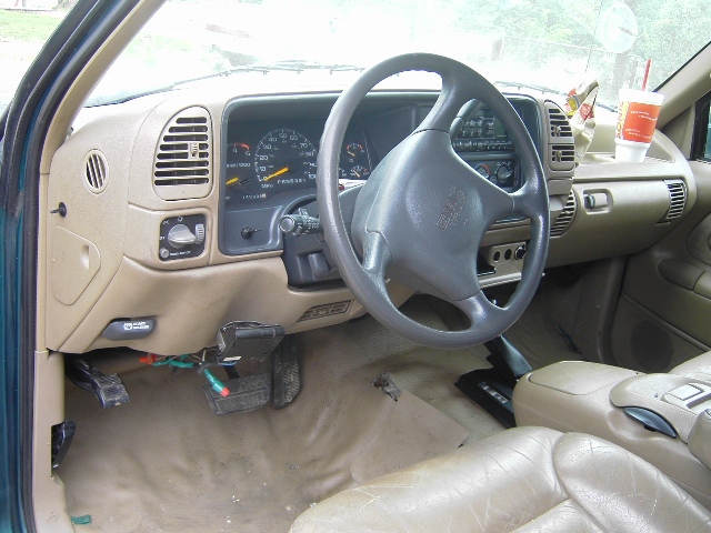 Interior of a 1995 GMC C/K Pickup, showing the dashboard, steering wheel, and seats