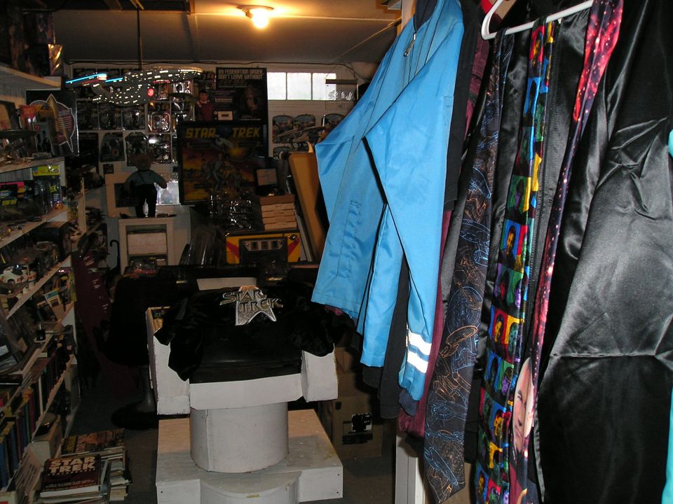 Room filled with Star Trek collectibles, including posters, toys, clothing, and ties