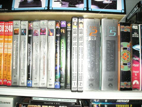 1984 Pontiac Fiero - A shelf displays a collection of Star Trek movies and series on DVD and VHS.