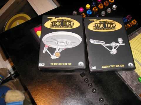 1984 Pontiac Fiero - DVDs for The Complete Star Trek Animated Adventures are displayed on a table with other items.