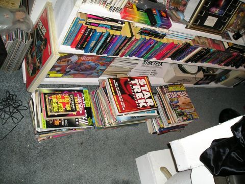 1984 Pontiac Fiero - A collection of science fiction magazines and books are piled on the floor and on shelves.