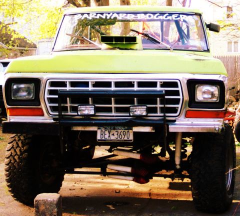 1978 Ford Bronco - Front view of a lifted 1978 Ford Bronco with a custom hood scoop and "BARNYARD BOGGER" windshield banner.