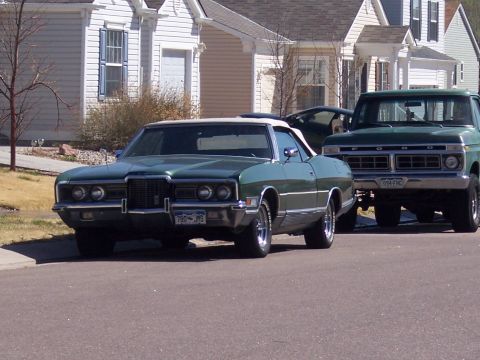 1972 Ford Ranchero - Two vehicles, a convertible and a pickup truck, are parked on a residential street.