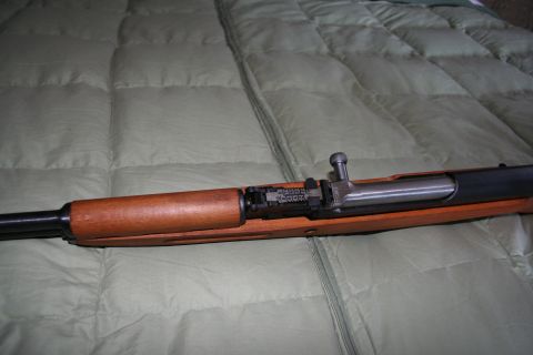 2004 Jeep TJ - Close-up of a rifle's bolt and receiver assembly, showing mechanical details.