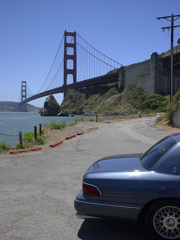 Blue sedan parked overlooking the Golden Gate Bridge in San Francisco