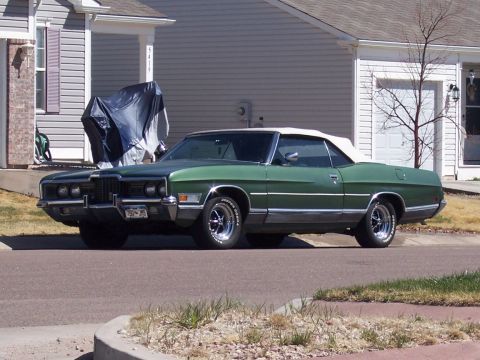 1972 Ford Ranchero - This green 1972 Ford Ranchero convertible features a white top and chrome accents.
