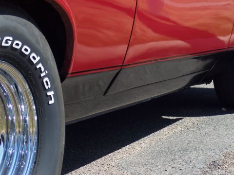 1972 Ford Ranchero - Side view of a red 1972 Ford Ranchero, highlighting the black trim and BFGoodrich tire.