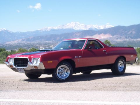 1972 Ford Ranchero - A red 1972 Ford Ranchero is parked outdoors with a mountain range visible behind it.