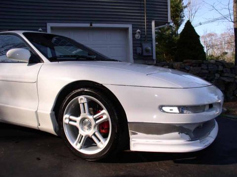 1996 Ford Probe - This 1996 Ford Probe GT features custom wheels and red brake calipers, viewed from the front quarter angle.