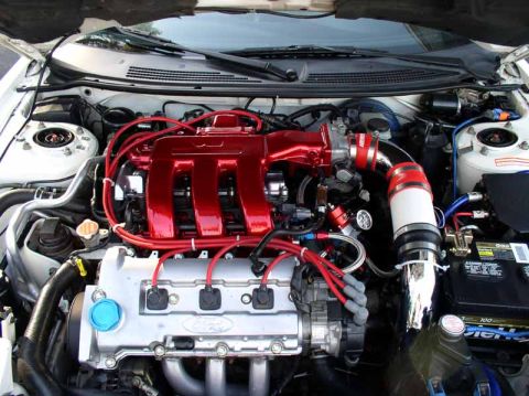 1996 Ford Probe - Close-up of a modified engine bay, a prominent red intake manifold and visible Ford badging.