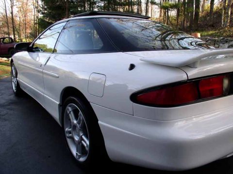1996 Ford Probe - The rear quarter of a white 1996 Ford Probe GT, showing its distinctive spoiler and taillight design.