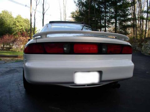 1996 Ford Probe - White 1996 Ford Probe GT parked on a driveway with trees in the background.