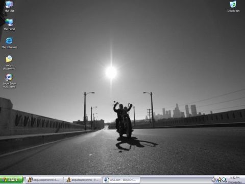 1989 Ford Bronco - A lone motorcyclist rides across a bridge with the sun shining brightly.