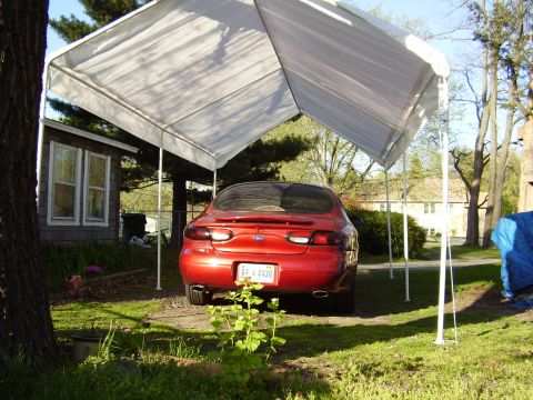 1997 Ford Taurus - This 1997 Ford Taurus is seen from the rear, parked under a white canopy on a sunny day.