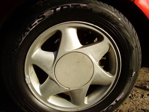 1997 Ford Taurus - A close-up of a car's wheel and tire.