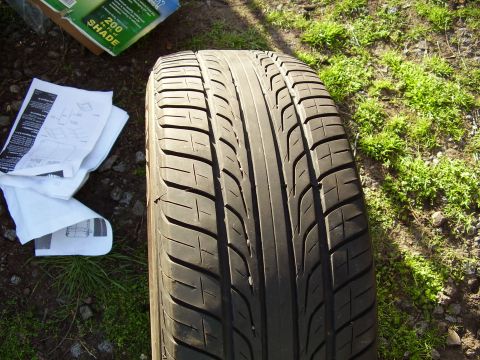 1997 Ford Taurus - A tire is shown with some documents and a box in the background.
