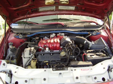 1997 Ford Taurus - The engine bay of a 1997 Ford Taurus shows the 3.0 V6 engine and associated components.