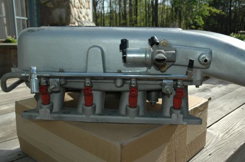 2000 Ford Mustang - Intake manifold assembly with fuel injectors and throttle body, likely for a Ford Mustang.