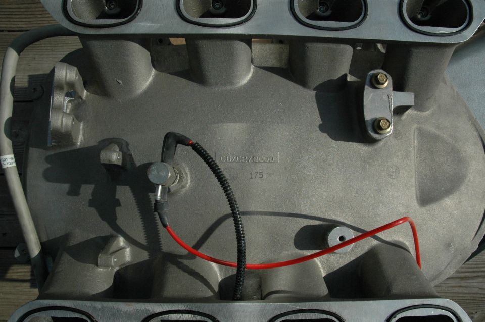 Engine intake manifold with date stamp 06/08/2000 and part number 175