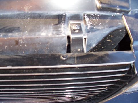 2003 Ford Ranger - Detail of the front grille on a 2003 Ford Ranger, showing its horizontal bar design and surrounding trim.