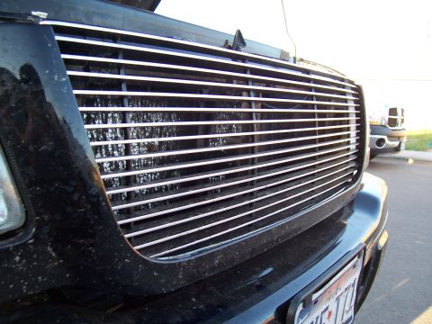 2003 Ford Ranger - Front grille of a 2003 Ford Ranger, with another vehicle in the background.
