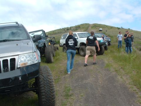 1994 Jeep YJ - Group of off-road vehicles gathered on a dirt path during an outdoor event.