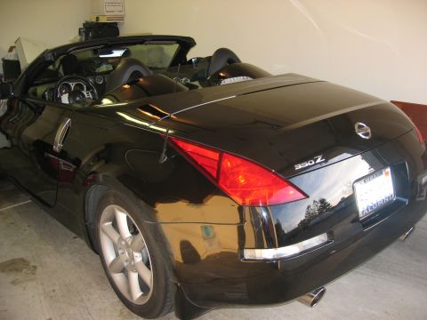 2004 Nissan 350Z - Rear view of a black convertible sports car with a 350Z badge and a license plate that reads 'ALUMNI'.