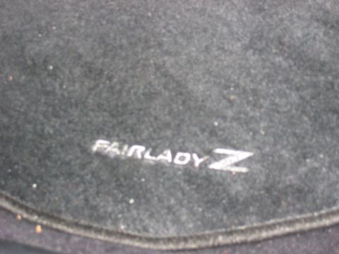 2004 Nissan 350Z - Embroidered Fairlady Z logo visible on a dark carpeted surface.