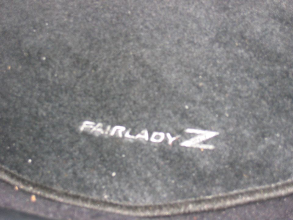 Fairlady Z logo on dark carpet