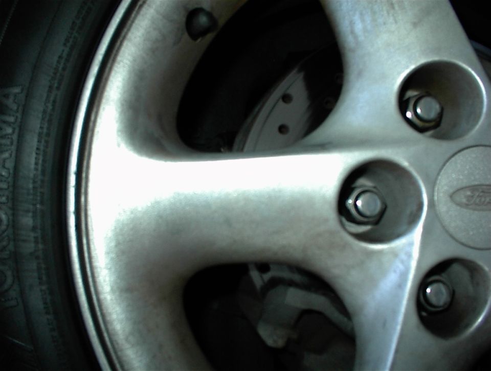 Close-up of silver Ford alloy wheel with Yokohama tire and visible lug nuts