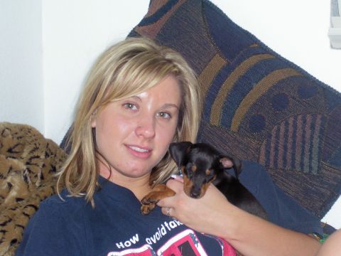 1991 Ford Bronco - Woman with a puppy, wearing a t-shirt with text.