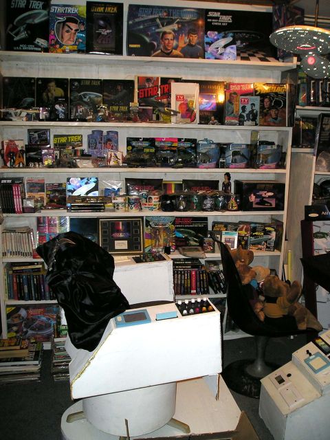 1984 Pontiac Fiero - A room filled with Star Trek collectibles, including toys, models, and display items, arranged on shelves.