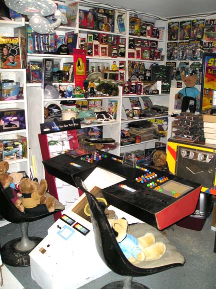 1984 Pontiac Fiero - A collector's room displays shelves packed with Star Trek merchandise, action figures, and various memorabilia.