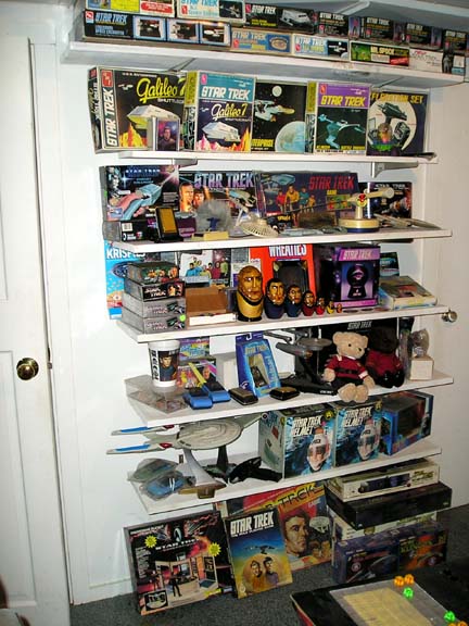 1984 Pontiac Fiero - A collection of Star Trek merchandise is displayed on shelves, including model kits and action figures.