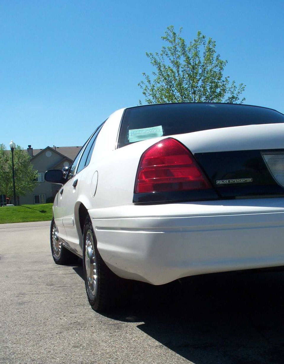 White 2001 Ford Crown Victoria, rear quarter view, clean condition, parked on asphalt