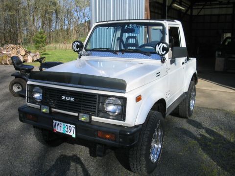 1987 Suzuki Samurai - This 1987 Suzuki Samurai features KC lights mounted on the windshield frame and a custom grille with 'ZUK' badging.