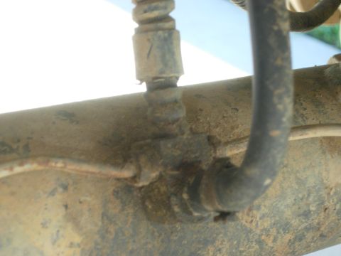 1995 Ford Bronco - Close-up view of a rear axle housing with brake lines, a Supermotors.net watermark.