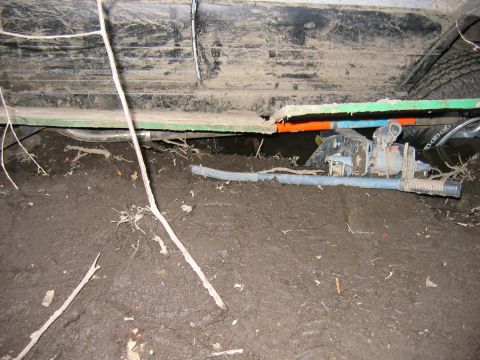 1995 Ford Bronco - This vehicle appears to be stuck in deep mud, with its undercarriage exposed and components visible.