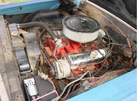 1964 Pontiac Tempest - The engine bay of a blue car is shown, a V8 engine and an aftermarket air filter. Text from Supermotors.net is visible.