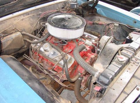 1964 Pontiac Tempest - The engine bay of a car shows a V8 engine with an aftermarket air cleaner and a radiator.