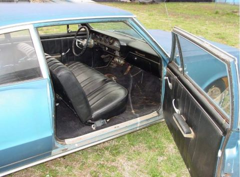 1964 Pontiac Tempest - Interior view of a blue 1964 Pontiac Tempest, showing the dashboard and front seats.