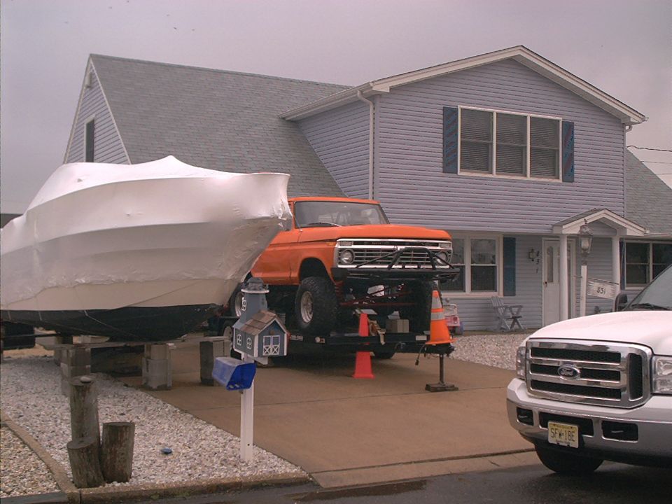 Orange 1970s Ford pickup truck with custom bumper, front view