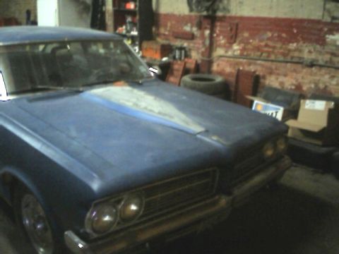 1964 Pontiac Tempest - Front view of a blue 1964 Pontiac Tempest in a garage setting.